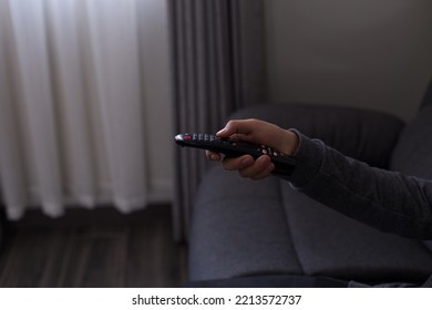 Hands Holding A Television Remote Control. Concept Of Leisure And Technology.