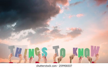 Hands Holding Up Things To Know Against Orange And Blue Sky With Clouds