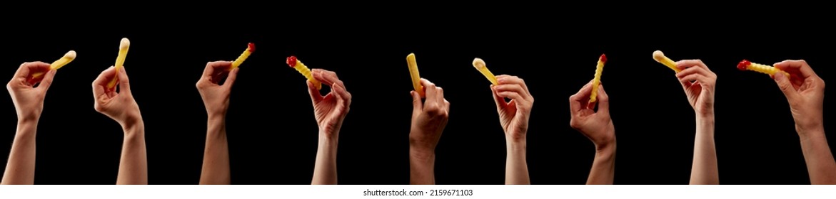 Hands holding various chips, pommes, or french fries on isolated black background as construction material for bbq or fast food advertisement - Shutterstock ID 2159671103