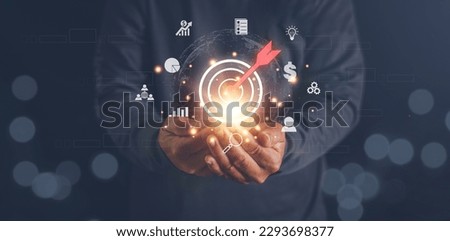 Hands holding virtual bullseye target dart board to business goals, Setup objectives and target for business investment concept, Digital marketing, Financial and banking, Digital link tech.