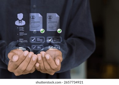 Hands holding virtual HR interface with employee resumes, profile checks, and data management system.