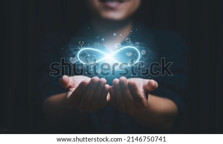 Hands holding virtual infinity with technology icon for symbol of connection to community metaverse world network system concept.