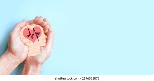 Hands holding wooden brain and heart, brain stroke, world heart day, world mental health day, Alzheimer concept. - Shutterstock ID 2196551873