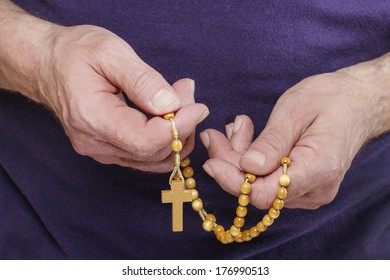 Hands Holding Wooden Rosary