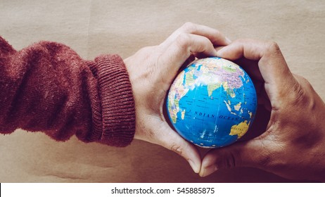 hands holding the world