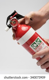 Hands Holds A Home Fire Extinguisher