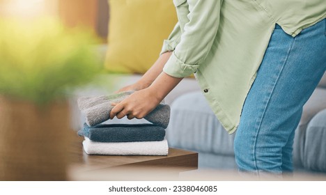 Hands, home and fold laundry on table for hygiene, cleaning and soft clothes for housework in living room. Woman, fabric and cotton towel on desk for organized house, service and routine in apartment - Shutterstock ID 2338046085