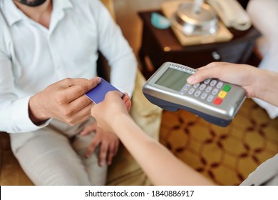Hands Of Hotel Guest Paying For Room Service With Credit Card