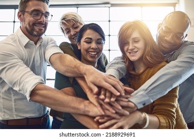 Hands in a huddle for teamwork, working together and unity between a business team of happy colleagues. A group of motivated and smiling creative designers with a mindset of support and - Shutterstock ID 2188929691
