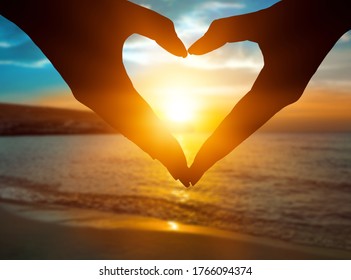 The hands of human doing the heart shape with the sun light passing through the hands - Shutterstock ID 1766094374