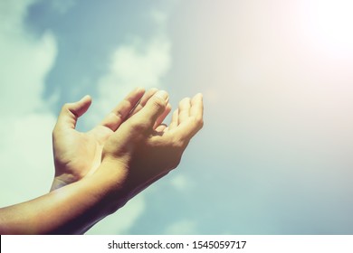 Hands of human are pray and worship on blue sky background with sunlight, Soul of prayer man, Spirituality with believe and religion