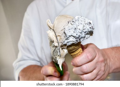 Hands Of The Ice Cream Maker Putting Ice Cream In The Waffle Cone, Cream And Chocolate Stracciatella Flavors