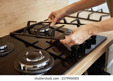 Hands Installing Gas Stove Grill After Cleaning, Kitchen Appliance Maintenance