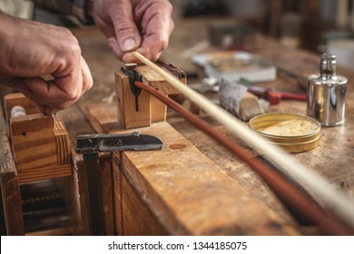 Hands Of An Instrument Maker Connecting The Hair To The Violin Bow