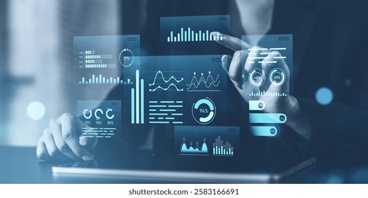 Hands interacting with virtual data charts and graphs in blue tones, futuristic transparent interface, on blurred background. Concept of analytics