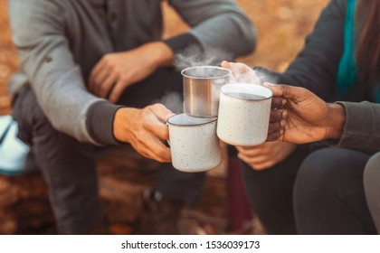 Hands of international hikers cheering up with camping cups, camping in forest, close up - Powered by Shutterstock