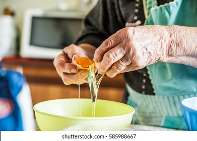 Hands Of Italian Grandma Holding Egg While Making Pasta