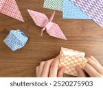 The hands of a Japanese woman folding origami