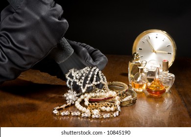 Hands Of A Jewelry Thief With Black Gloves