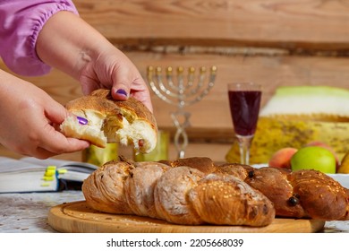 The Hands Of A Jewish Woman Break The Challah During The Shabbat Meal With A Blessing. Horizontal Photo