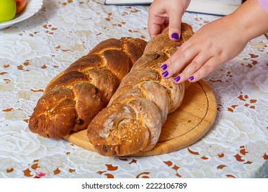 The Hands Of A Jewish Woman Break The Challah For The Traditional Shabbat Blessing. Horizontal Photo