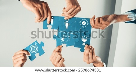 Hands join together to complete a puzzle, symbolizing teamwork, shared goals, and success in a professional context, highlighting collaboration and problem-solving efforts. Amity