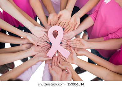 Hands joined in circle holding breast cancer struggle symbol  on white background - Shutterstock ID 153061814