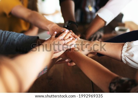 Hands joined over wooden table