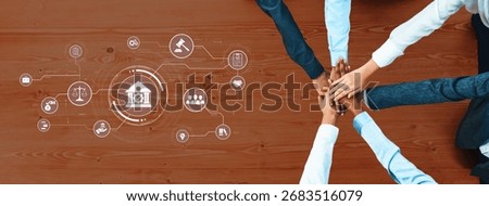 Hands joined together above a table, surrounded by digital legal icons, illustrate teamwork and collaboration in a professional legal environment, emphasizing unity. Trope