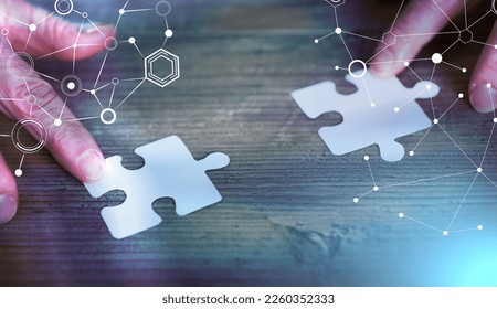 Hands joining two puzzle pieces, teamwork concept; light effect - Shutterstock ID 2260352333