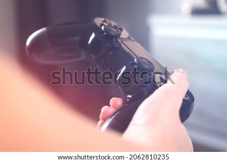 Hands with joystick controller, concept of streaming online, gaming and esports challenge. Closeup view to gamepad