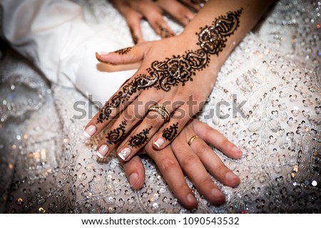 hands of just married couple, with a henna tatoo