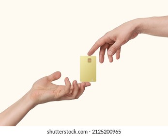 Hands keep gold bank card in spotlight, isolated on beige light background