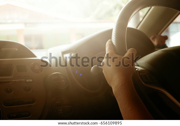 hands of a kid with car steering wheel is\
ready on the move in the modern life\
style.
