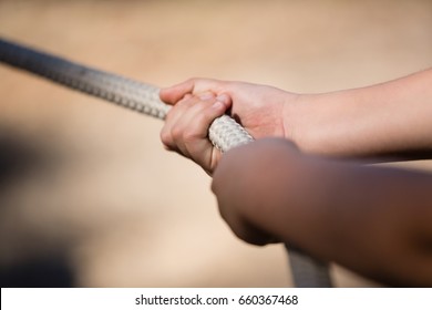 Hands of kid practicing tug of war during obstacle course in the boot camp - Powered by Shutterstock