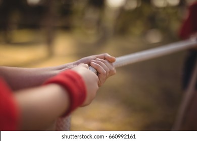 Hands of kid practicing tug of war during obstacle course in boot camp - Powered by Shutterstock