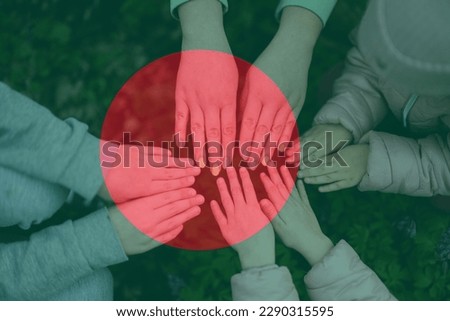 Hands of kids on background of Bangladesh flag. Bangladeshi patriotism and unity concept.