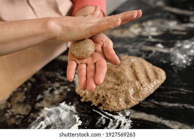 hands kneading cookie dough balls