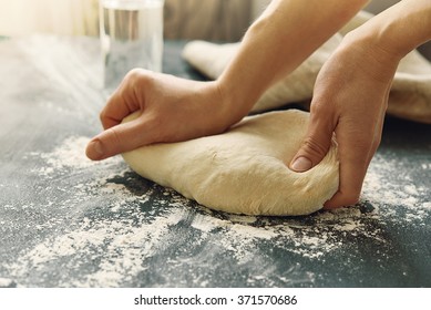 hands kneading a dough. toned image