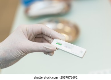 Hands of laboratory assistant in gloves analyzing blood sample. Prevention. Pneumonia diagnosing. COVID-19 and coronavirus identification. Pandemic