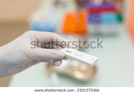 Hands of laboratory assistant in gloves analyzing blood sample. Prevention. Pneumonia diagnosing. COVID-19 and coronavirus identification. Pandemic
