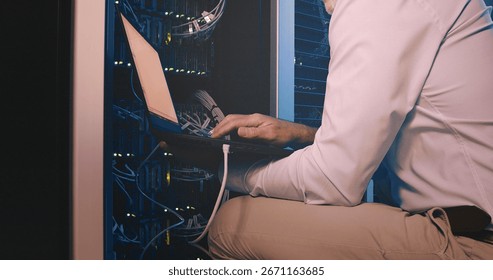 Hands, laptop and cable connection at data center for system test, diagnostics or troubleshooting. Engineer, cybersecurity and tech in server room for network configuration and firewall installation