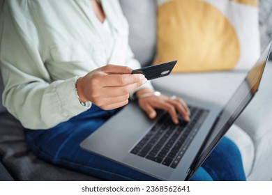 Hands, laptop and credit card for home online shopping, fintech payment and e commerce on sofa. Closeup of person typing on computer for internet banking, website subscription or application for loan