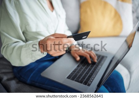 Hands, laptop and credit card for home online shopping, fintech payment and e commerce on sofa. Closeup of person typing on computer for internet banking, website subscription or application for loan