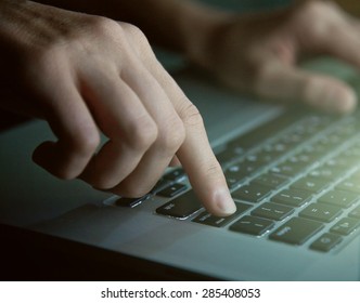 hands with laptop in night pressing enter button - Powered by Shutterstock