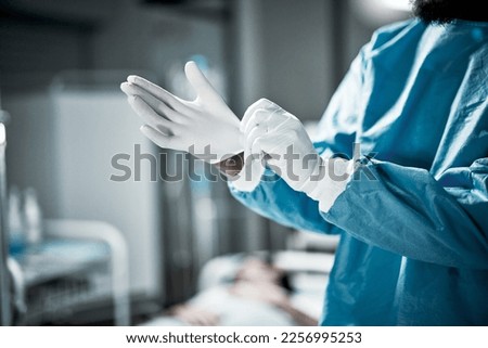 Hands, latex gloves and surgeon preparing for operation in a consultation room in the hospital. Healthcare, surgical and medical doctor ready for surgery in ER or emergency theatre in medicare clinic