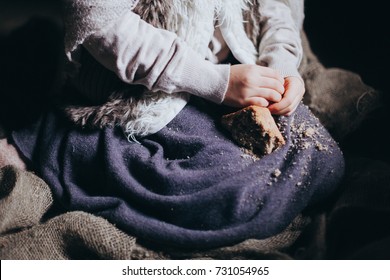 Hands Little Hungry Impoverished Poor Girls In Poor Old Clothes Holding A Piece Of Bread, The Problem Of Starving Children And Charity, Copy Space