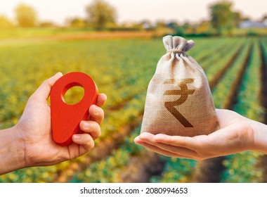 Hands with location pin and indian rupee money bag. Land market. Estimation cost of plots. Agriculture agribusiness. Transport and construction industry. Buying and selling land.