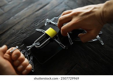 Hands Locking Smartphone with Chain and Padlock Symbolizing Digital Security and Privacy Protection - Powered by Shutterstock