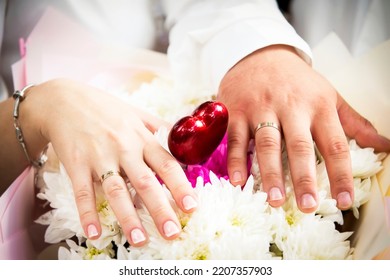 Hands Of Lovers With Wedding Rings. Wedding Day Of A Heterogeneous Couple.